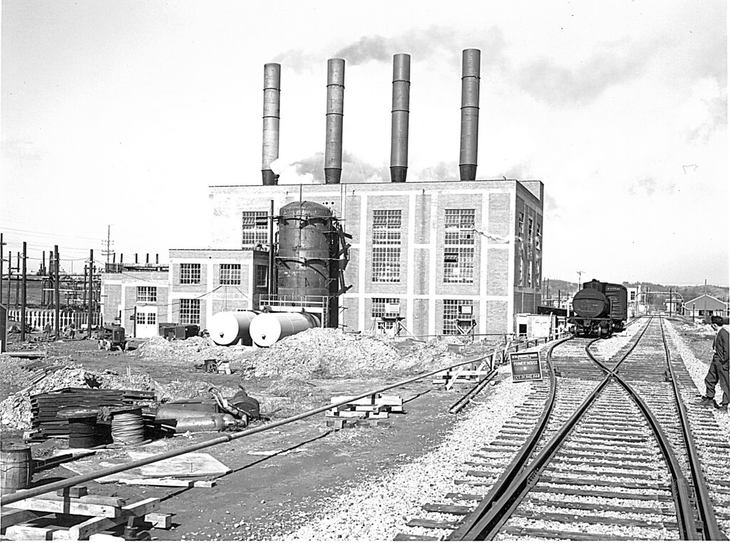 The powerhouse under construction, with four smokestacks and railway tracks in the foreground